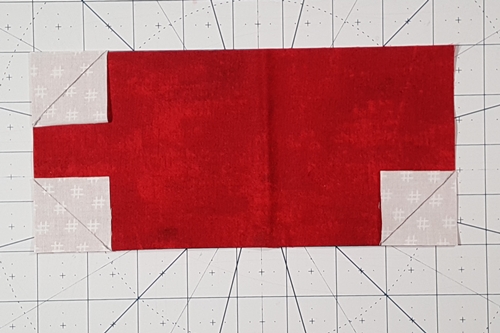 Step 1a Christmas Stocking Quilt Block Pattern: draw a diagonal line from corner to corner on the wrong side of squares (F).